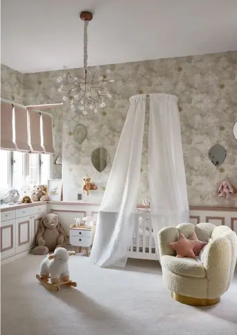  ?? ?? From top: A Moooi Heracleum II hanging lamp floats overhead in the nursery, which is furnished with a cuddly armchair from Eichholtz, and the Stars and Monkeys wallpaper from Les Dominotier­s; This airy bathroom continues the apartment’s elegant off-white palette