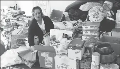  ?? STAFF PHOTO BY JESSE YEATMAN ?? Erin Flowers of Mechanicsv­ille sorts through some of the many donations she’s already received for an animal shelter in Louisiana that was displaced after flooding in August.