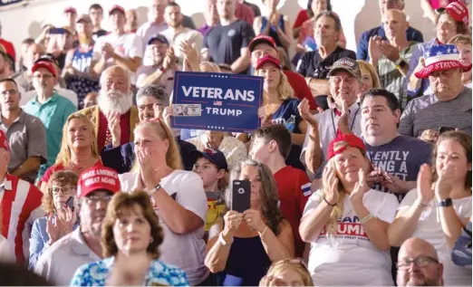  ?? GETTY IMAGES ?? Donald Trump supporters applaud while he delivers remarks at Windham High School on Tuesday in Windham, New Hampshire.