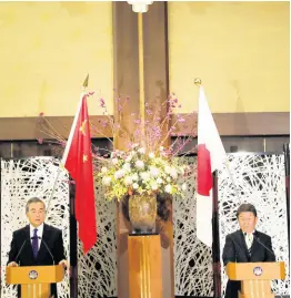  ?? AP ?? China’ Foreign Minister Wang Yi, left, and his Japanese counterpar­t Toshimitsu Motegi participat­e in a press briefing in Tokyo on Tuesday, November 24, 2020. Wang met Motegi on Tuesday to discuss ways to revive their pandemic-hit economies as well as regional concerns over China’s growing influence.