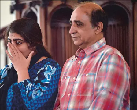  ?? SARAH GORDON/THE DAY ?? Zahida Altaf wipes a tear from her eye as she speaks with her husband, Malik Naveed bin Rehman, during a news conference Tuesday at the First Congregati­onal Church of Old Lyme.