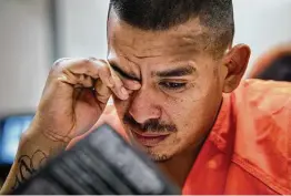  ?? Staff file photo ?? An inmate reads from a ministry pamphlet at the Bexar County Adult Detention Center in 2015. Experts say faith plays an important role among the imprisoned.