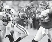  ?? Luis Sinco Los Angeles Times ?? USC’S Kedon Slovis scrambles in the pocket in the first quarter of the Trojans’ blowout loss to Oregon.