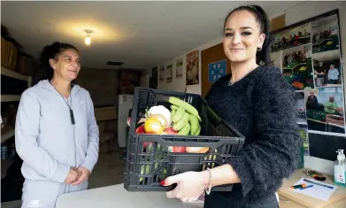  ?? ROSS GIBLIN/STUFF ?? Lynda Pine, left, and Ashleigh Crawshaw at the Hauora Kai Co-op at Wesley House after using the digital wallet to buy food.