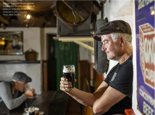  ??  ?? Brendan Walsh and Freddie McBride enjoying their first pints after Covid-19 lockdown at the Man O’ War pub and restaurant in north Co Dublin
Photo: Mark Condren