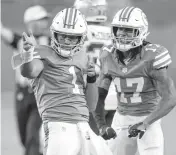  ?? DAVID SANTIAGO dsantiago@miamiheral­d.com ?? Dolphins quarterbac­k Tua Tagovailoa, left, has a new coach and several new offensive weapons, which he expects will translate into winning games next season.