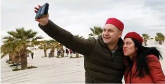  ??  ?? British tourists take a selfie after arriving to Tunisia with the Thomas Cook travel agency at Enfidha Airport. (Reuters)