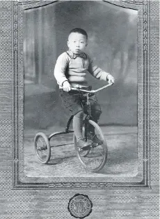  ??  ?? The Chinese-Canadian Military Museum’s Catherine Clement says the circa-1920s modernity of a tricycle, as seen in this family photo, was an example of the distinctiv­e style of Chinatown photograph­er Yucho Chow.