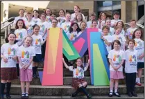  ??  ?? Pupils from Glasgow Gaelic School launch the new logo for the Royal National Mod on the Royal Concert Hall steps