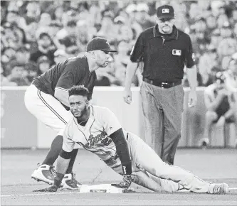  ?? FRED THORNHILL THE CANADIAN PRESS ?? Detroit Tigers’ Niko Goodrum slides safely into third with a triple as Blue Jay Kendrys Morales waits for the ball in the 10th inning of their American League baseball game in Toronto on Monday afternoon.