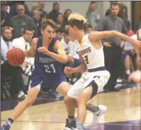  ?? The Sentinel-Record/Richard Rasmussen ?? LION ATTACK: Jessievill­e’s Chase Pedersen (21) dribbles against Fountain Lake’s Ahman Johnson (3) Tuesday at the Cobras’ Irvin J. Bass Gymnasium-Sammy Lambert Court. A fourth quarter push helped the Lions win 53-48 over their north Garland County rivals.