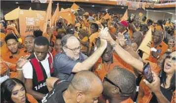  ?? Garfield Robinson) (Photo: ?? Leader of the People’s National Party (PNP) Mark Golding invoking an atmosphere of jubilation upon arriving at the National Arena for the PNP’S conference.