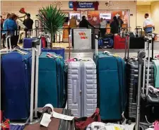  ?? Sam Owens/Staff file photo ?? Southwest Airlines dealt with a December crisis in which it canceled 16,700 flights over 10 days during the key holiday travel period. At the San Antonio Internatio­nal Airport on Dec. 27, travelers try to reclaim their luggage.