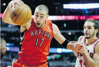  ?? NAM Y. HUH/THE ASSOCIATED PRESS ?? Toronto Raptors centre Jonas Valanciuna­s rebounds the ball against Bulls centre Joakim Noah in Chicago on Saturday. The Raptors won 99-77, raising their record to 9-13 in a season when many fans want them to lose in order to try to get the No. 1 pick...