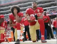  ?? AP PHOTO/MARCIO JOSE SANCHEZ, FILE ?? In this 2016 file photo, San Francisco quarterbac­k Colin Kaepernick, left, and safety Eric Reid kneel during the national anthem before an NFL football game against the Dallas Cowboys in Santa Clara, Calif. Kneeling by players across the league to...