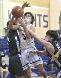  ?? PETE BANNAN — MEDIANEWS GROUP ?? West Chester Rustin’s Peter Reinheimer (3) goes up against Great Valley’s Quintin Wrabley and Max DeMedio (22) as the Golden Knights went on to a 62-55victory.