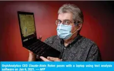  ?? — AFP ?? OrphAnalyt­ics CEO Claude-Alain Roten poses with a laptop using text analysis software on Jan 6, 2021.