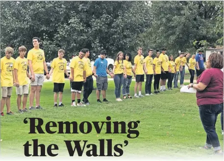  ??  ?? Marsha Herron, a member of Wildewood Christian Church (Disciples of Christ), guides youths through a “cultural walk” exercise during the “Removing the Walls Together” racial healing symposium at Wildewood, 6900 N Kelley. [CARLA HINTON PHOTOS/ THE OKLAHOMAN]