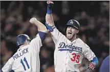  ?? Yong Teck Lim Getty Images ?? CODY BELLINGER, right, with Dodgers teammate A.J. Pollock, regressed at the plate in 2018 after his first two stellar seasons.