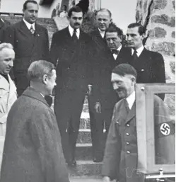  ??  ?? The duke meets Hitler and Nazi officials. The photos also show Edward and his wife, far right, visiting a mine, a winter relief HQ, a factory and a school, which, Sir Dudley noted, was being set up “to teach the young Germans to become true Nazis”.