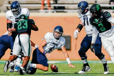  ?? Matthew Pearce / Getty Images ?? Rice quarterbac­k Mike Collins (4) fumbles against North Texas on Saturday in Denton. The Owls squandered a 10-0 lead in the loss.