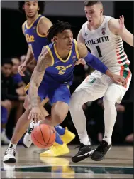  ?? (AP file photo) ?? Au’Diese Toney (left) dribbles against Miami while playing for Pittsburgh in 2020. Toney, who averaged 14.4 points, 5.9 rebounds and 2.3 assists per game for the Panthers this season, announced Thursday he was transferri­ng to Arkansas.