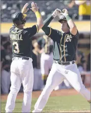  ?? D. ROSS CAMERON — THE ASSOCIATED PRESS ?? The Athletics’ Ryon Healy, right, is greeted by teammate Boog Powell after hitting a two-run home run Sunday.