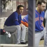  ??  ?? Harvey sits in the dugout during Friday night’s game.