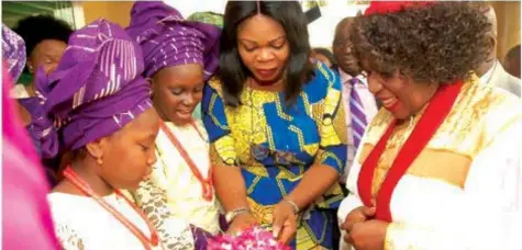  ??  ?? Archbishop, Church of God Mission Int’l. Inc. (CGMI Global), Her Grace, Most Rev. (Dr.) Margaret Benson Idahosa (right); Head, Children Department, CGMI Lagos Bishopric, Deaconess Margaret Adesuwa Igho-orere with the children presenting a welcome gift...