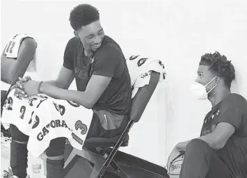  ?? COURTESY OF MIAMI HEAT ?? Heat center Bam Adebayo (left) shares a moment at Heat camp with Jimmy Butler.