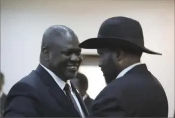  ?? Associated Press ?? Salva Kiir, right, president of South Sudan, and Riek Machar, the new vice president, greet each other after a swearing-in ceremony Saturday in Juba, South Sudan.