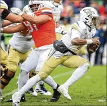  ?? GETTY IMAGES ?? A refocused James Graham had an impressive Saturday in Charlottes­ville, Virginia, one week after being benched at halftime. The redshirt freshman passed for 229 yards and two touchdowns and added a rushing TD.