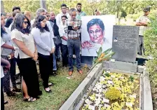  ?? AFP ?? Family members and friends of Lasantha Wickrematu­nga attend a memorial service at his grave in the Kanatte cemetery on January 8 to mark the tenth anniversar­y of his assassinat­ion.