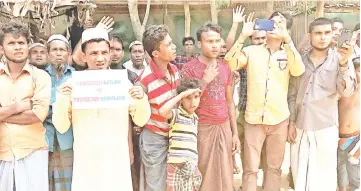  ?? — Reuters photo ?? Rohingya refugees line the streets as United Nations Security Council convoy passes by, outside Kutupalong Refugee Camp in Cox’s Bazar, Bangladesh in this file photo.