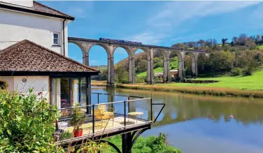  ?? Andrew Triggs ?? An idyllic scene as Great Western Railway Class 150 diesel multiple unit 150219 crosses Calstock Viaduct in south-east Cornwall, working 2G81, the 14.28 Plymouth to Gunnislake service on April 18. The DMU is one of only a few remaining trains in the GWR fleet to still carry the now obsolete First Great Western blue and magenta colours.