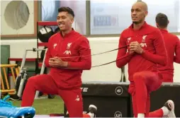  ?? — LIVERPOOL ?? Roberto Firmino (left) and Fabinho train ahead of their Carabao Cup match against Arsenal in Liverpool on Tuesday.