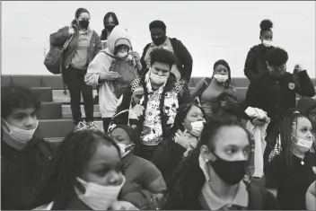  ?? MATT ROURKE/AP ?? STUDENTS WEARING MASKS AS A PRECAUTION against the spread of the coronaviru­s line up to receive KN95 protective masks at Camden High School in Camden, N.J., on Feb. 9. U.S. COVID-19 cases are up, leading a smattering of school districts, particular­ly in the Northeast, to bring back mask mandates and recommenda­tions for the first time since the omicron winter surge ended and as the country approaches 1 million deaths in the pandemic.