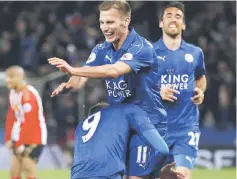  ??  ?? Leicester City’s Jamie Vardy (bottom) celebrates with Marc Albrighton after scoring against Sunderland. — Reuters photo