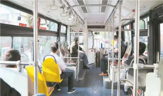  ?? ?? Passengers take a public transport bus in Jinshan yesterday when five bus lines in the suburban district resumed operations. — Ti Gong