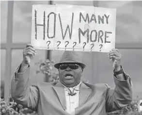  ?? Chuck Burton / Associated Press ?? Rev. Dr. Arthur Prioleau holds a sign during a protest in the shooting death of Walter Scott in North Charleston, S.C. “They Can’t Kill Us All” examines the spate of shootings that has sparked the Black Lives Matter movement.