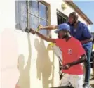  ?? Picture: DESMOND COETZEE ?? FOR MADIBA: Sweetwater­s Masters Football Club executive members and players handed out food parcels and gave the homes of needy families a facelift