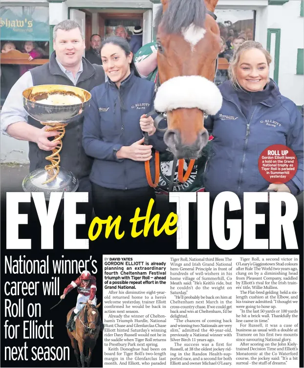  ??  ?? ROLL UP Gordon Elliott keeps a hold on the Grand National trophy as Tiger Roll is paraded in Summerhill yesterday