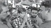  ??  ?? ■ Dr Kishore Chandra Das (in checked shirt) salutes townsfolk before leaving Tentulikhu­nti on Sunday. HT PHOTO