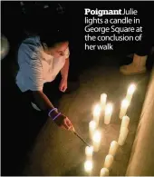  ??  ?? Poignant Julie lights a candle in George Square at the conclusion of her walk