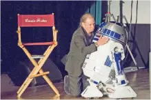  ??  ?? Todd Fisher hugs Star Wars character R2-D2 at the Carrie Fisher and Debbie Reynolds Memorial Service.