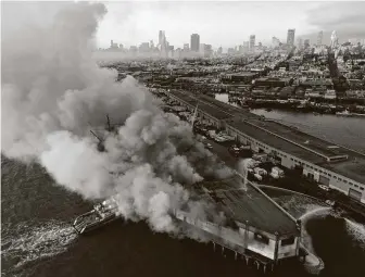  ?? Paul Kuroda / San Francisco Chronicle ?? Firefighte­rs spray water on the Pier 45 fire, which began early Saturday in San Francisco. The fire threatened the SS Jeremiah O’Brien, a liberty ship that stormed Normandy on D-Day in 1944.