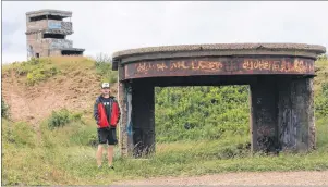  ??  ?? Yanick MacLean is at one of three searchligh­t positions with Chapel Point Battery command post in the background.