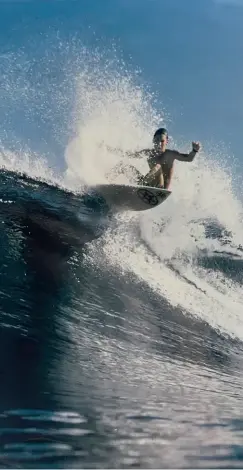  ?? -------------------------------------------------------------------- ?? Garrett McNamara (pictured off the North Shore of Oahu as a teen) has acquired more than 500 stitches during a lifetime of surfing.