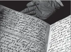  ?? FRANK AUGSTEIN/AP PHOTO ?? A university assistant shows fragments of a Quran Wednesday at the University in Birmingham in Birmingham, England. The university said Wednesday that scientific tests prove a Quran manuscript in its collection is one of the oldest known and may have...