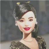  ?? ?? “It looks like me for sure,” says Kristi Yamaguchi of the new Barbie doll. “I mean, it has the bangs that are the ’90s.”